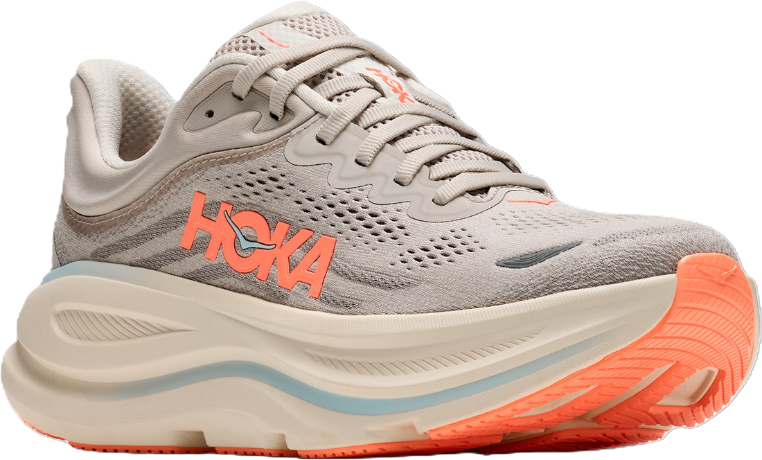 A Hoka running shoe in light gray and off-white with bright orange branding and outsole accents, shown from a side profile on a white background.